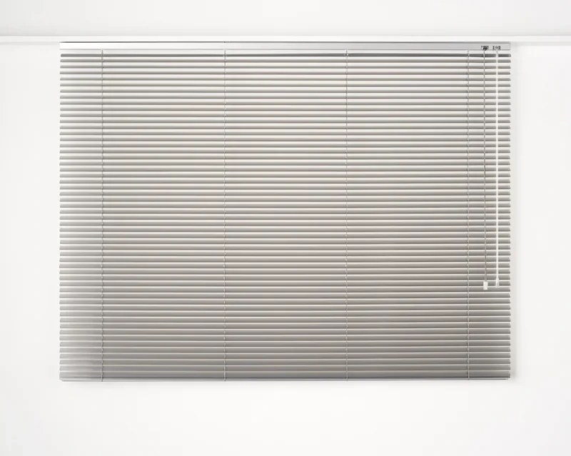 Silver 25 mm Slimline aluminium venetian blind, plain box headrail under the ceiling, colour-matched ladders, cord and clear wand on the right