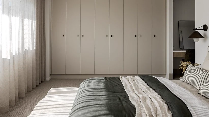 Bedroom with floor-length S-Fold sheer curtains hung from the ceiling line