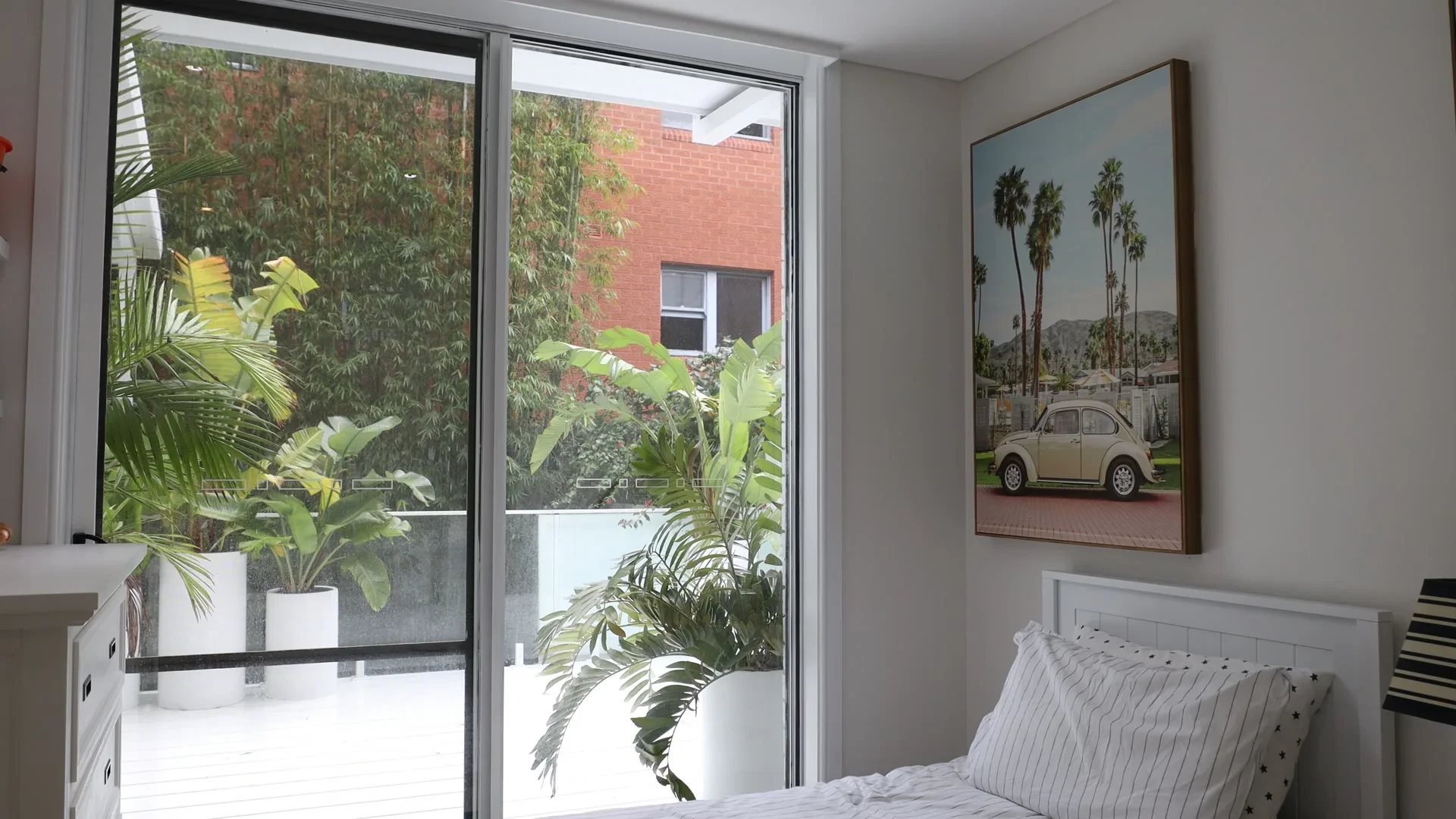 Bedroom sliding door and palms at Harries' home