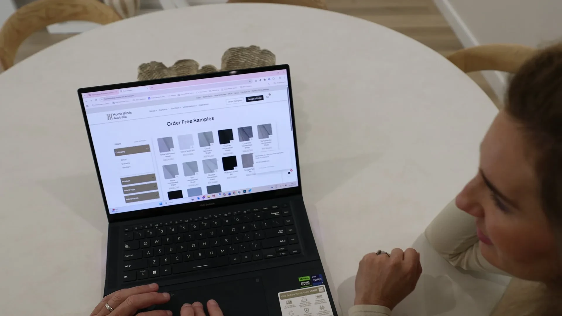 A laptop on a kitchen table showing the Home Blinds Australia free samples page
