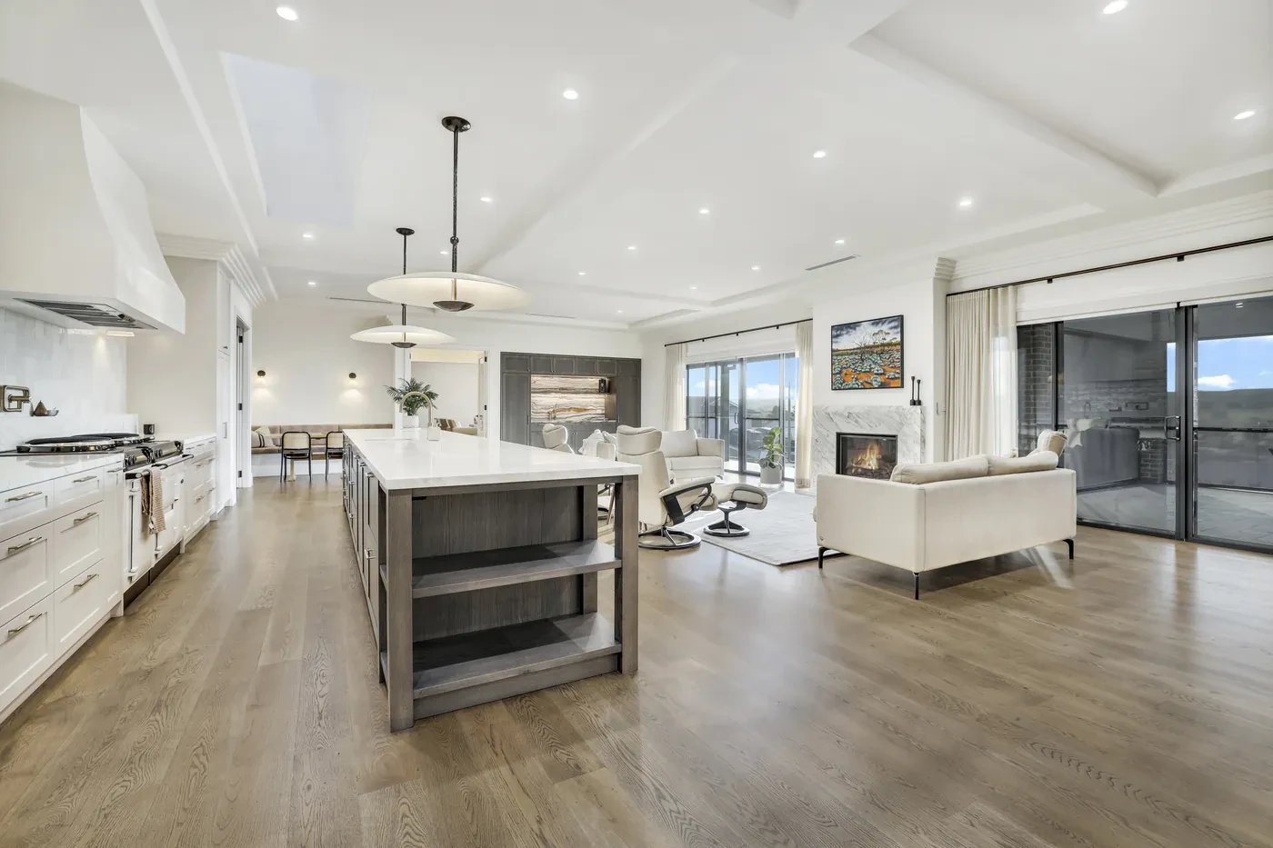 Open living and kitchen with sheer curtains on the glass doors Open living and kitchen with sheer curtains on the glass doors