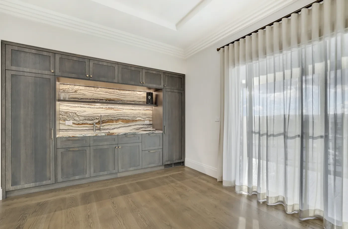 Media wall with sheer curtains to the side Media wall with sheer curtains to the side