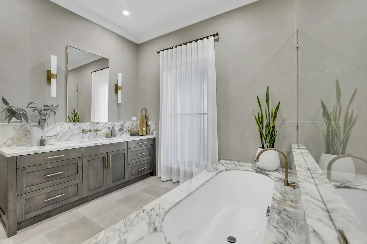 White sheer curtain beside a marble bath White sheer curtain beside a marble bath