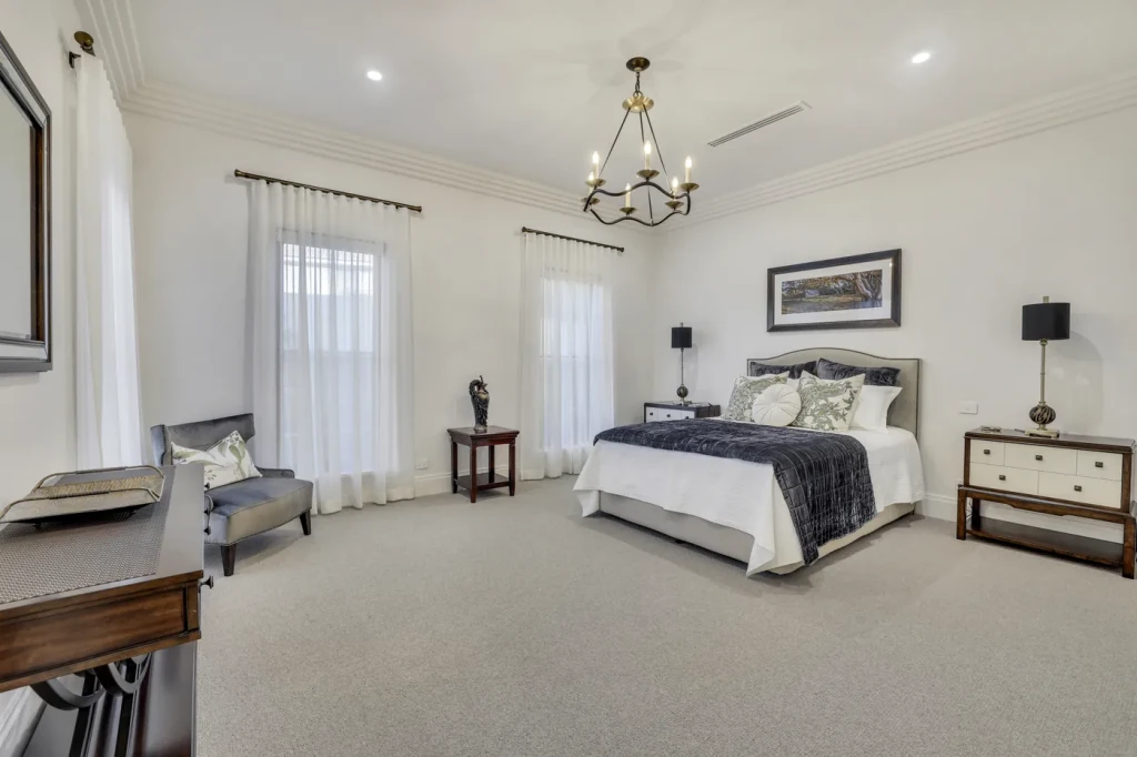Bedroom with sheer curtains and a chandelier Bedroom with sheer curtains and a chandelier