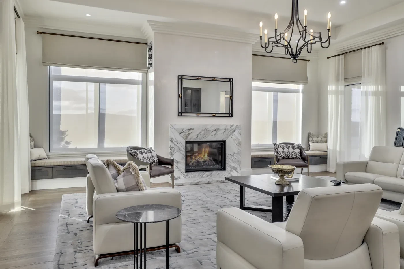 Formal living room with a marble fireplace and sheer curtains Formal living room with a marble fireplace and sheer curtains