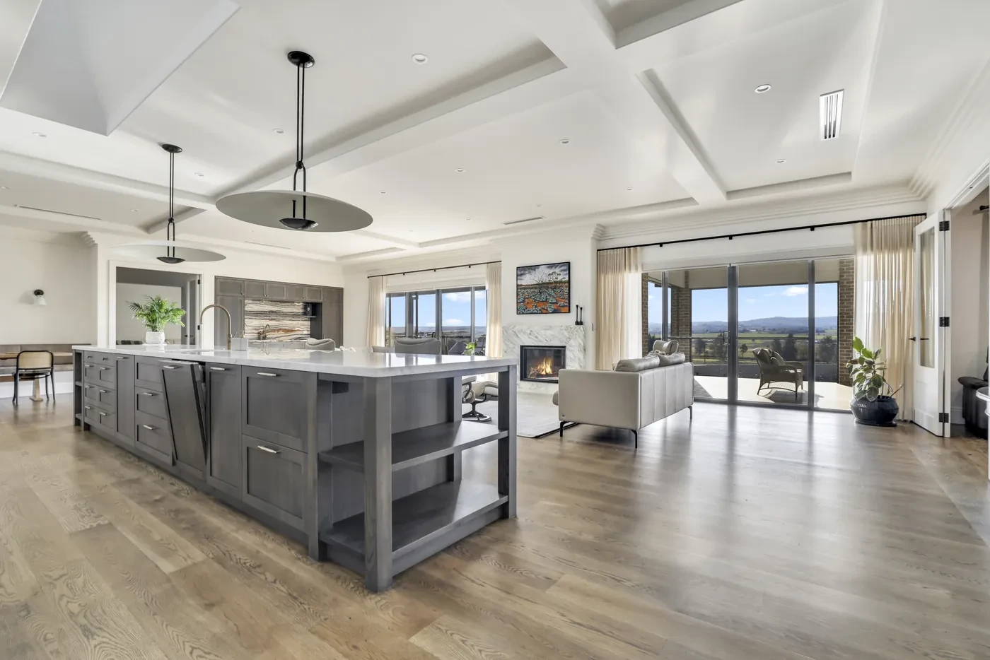 Open-plan kitchen with sheer curtains across the glass doors Open-plan kitchen with sheer curtains across the glass doors