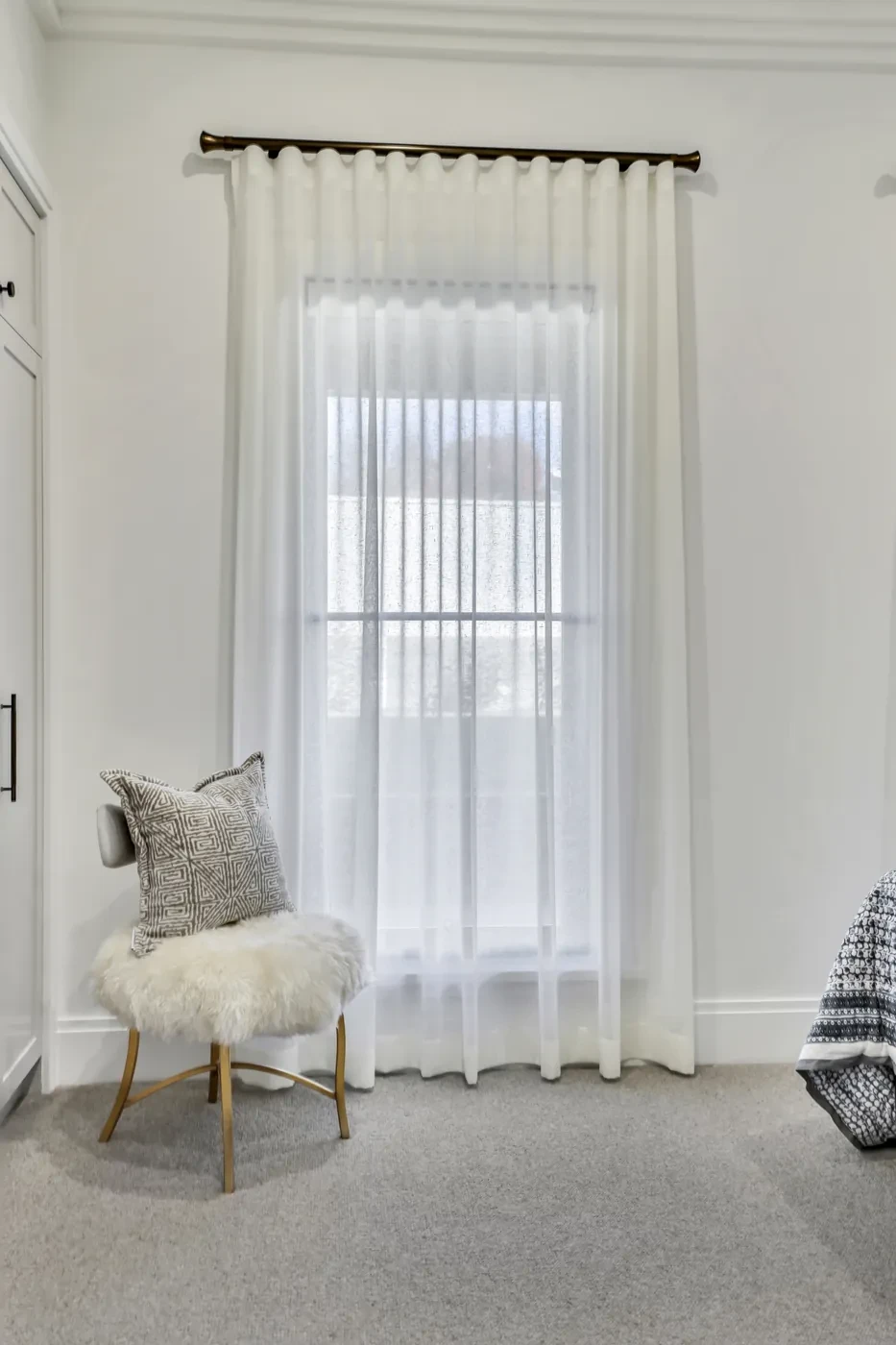 A single window with a sheer curtain A single window with a sheer curtain