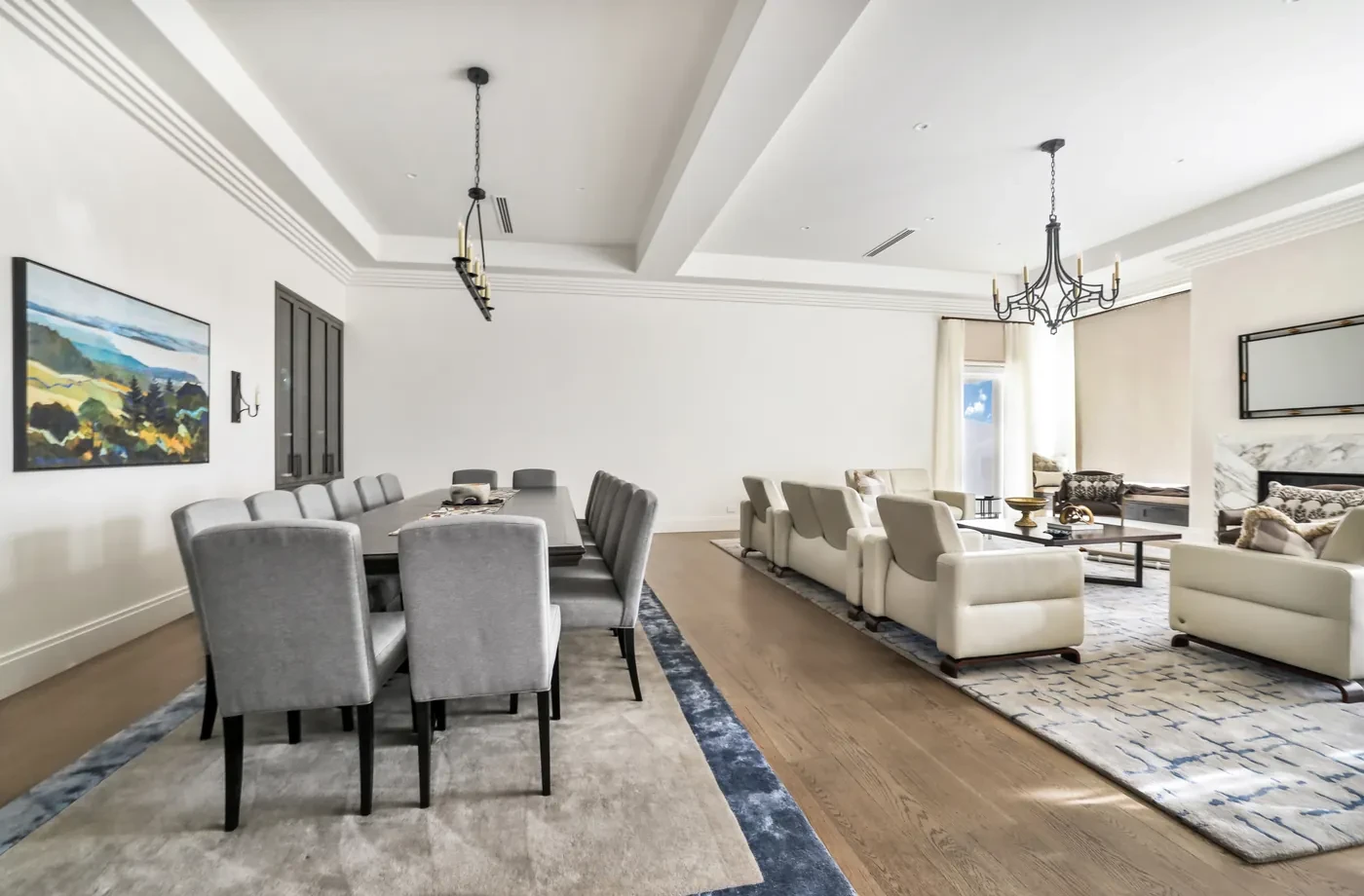 Dining room opening to a living room with sheer curtains Dining room opening to a living room with sheer curtains