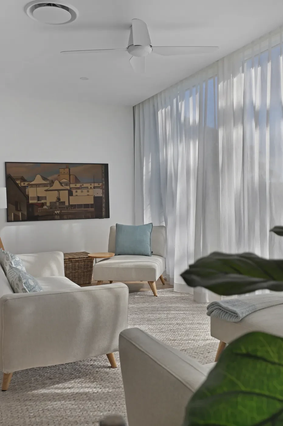 Sheer curtains and an armchair in a living room Sheer curtains and an armchair in a living room