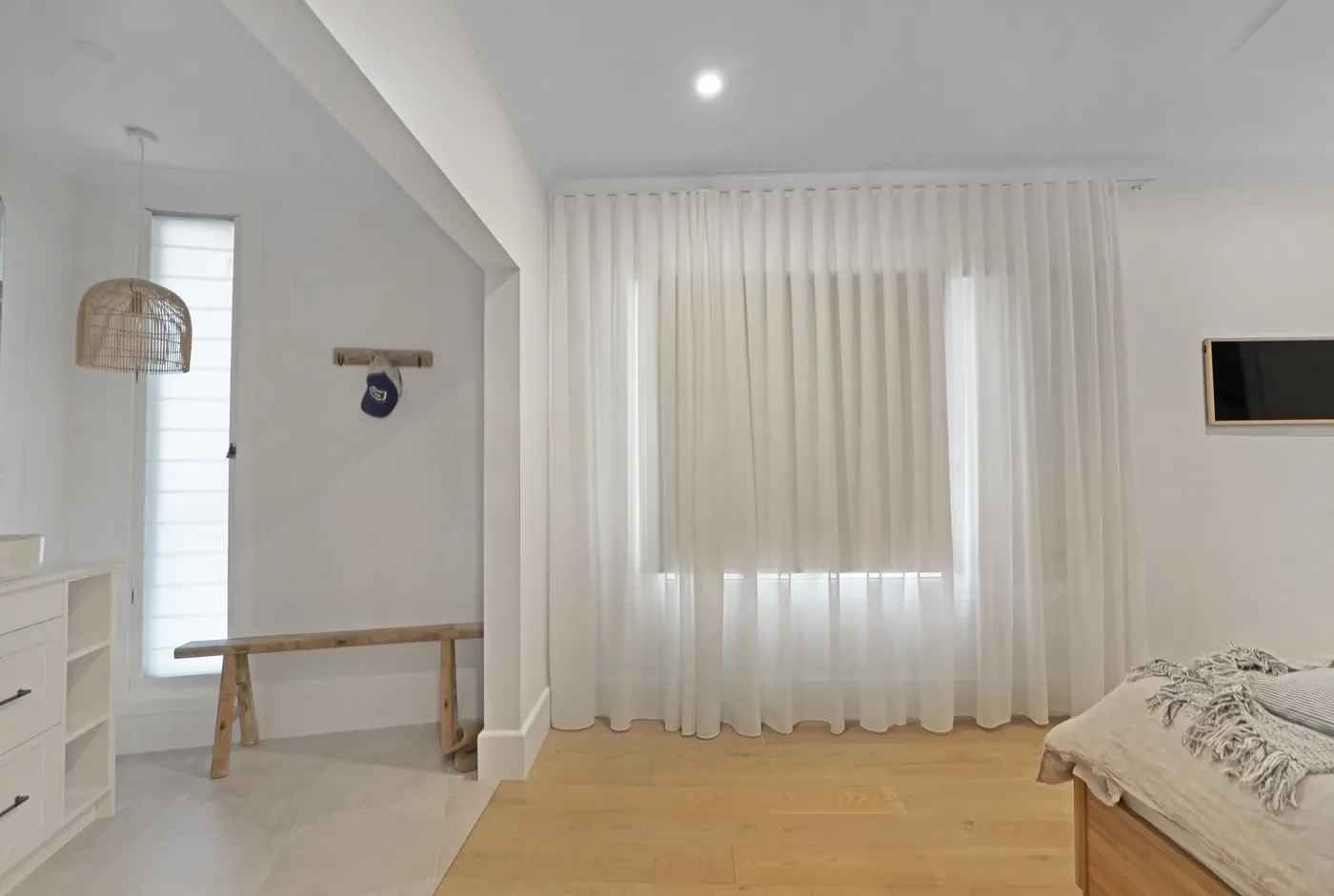 Bedroom with a wall of sheer curtains Bedroom with a wall of sheer curtains