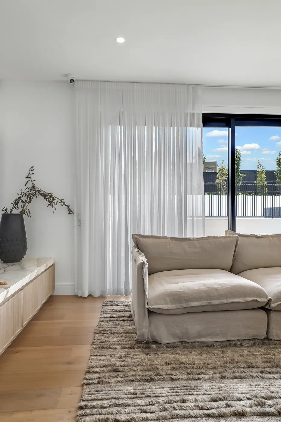 Sheer curtains in the corner of a living room Sheer curtains in the corner of a living room
