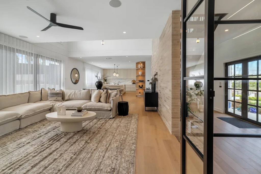 Living room with sheer curtains and a stone feature wall Living room with sheer curtains and a stone feature wall