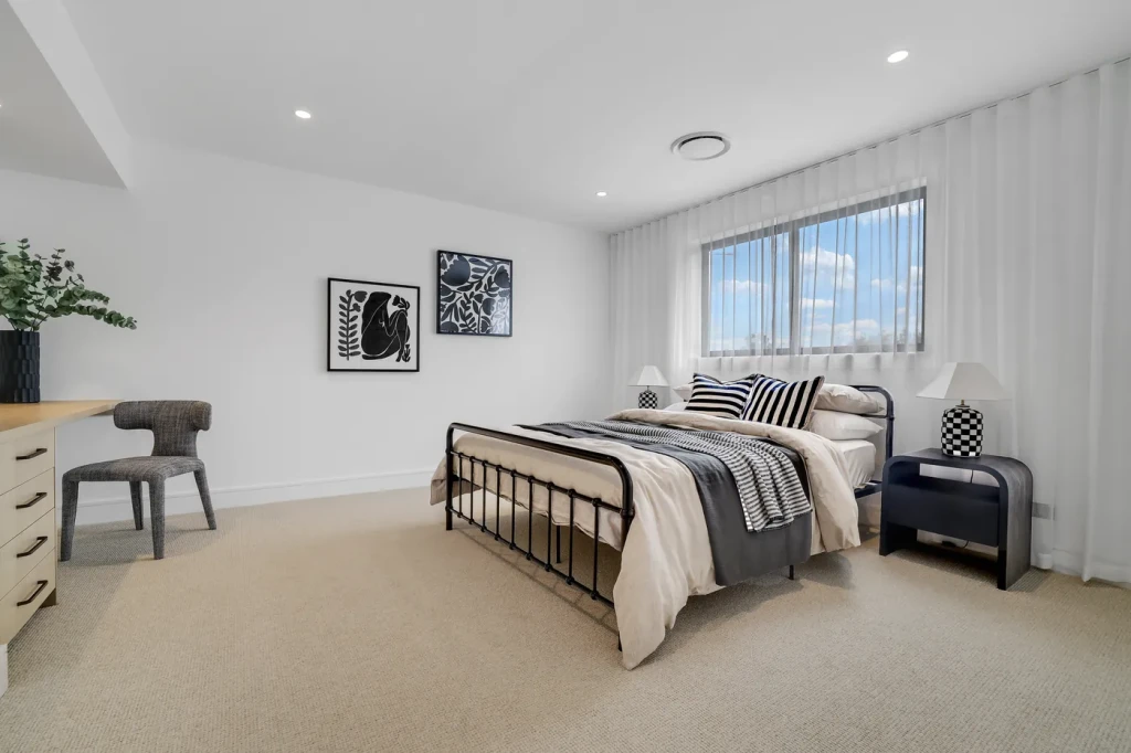 Bedroom with sheer curtains beside a study desk Bedroom with sheer curtains beside a study desk