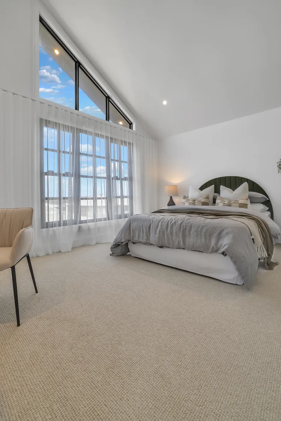 Raked-ceiling bedroom with sheer curtains Raked-ceiling bedroom with sheer curtains