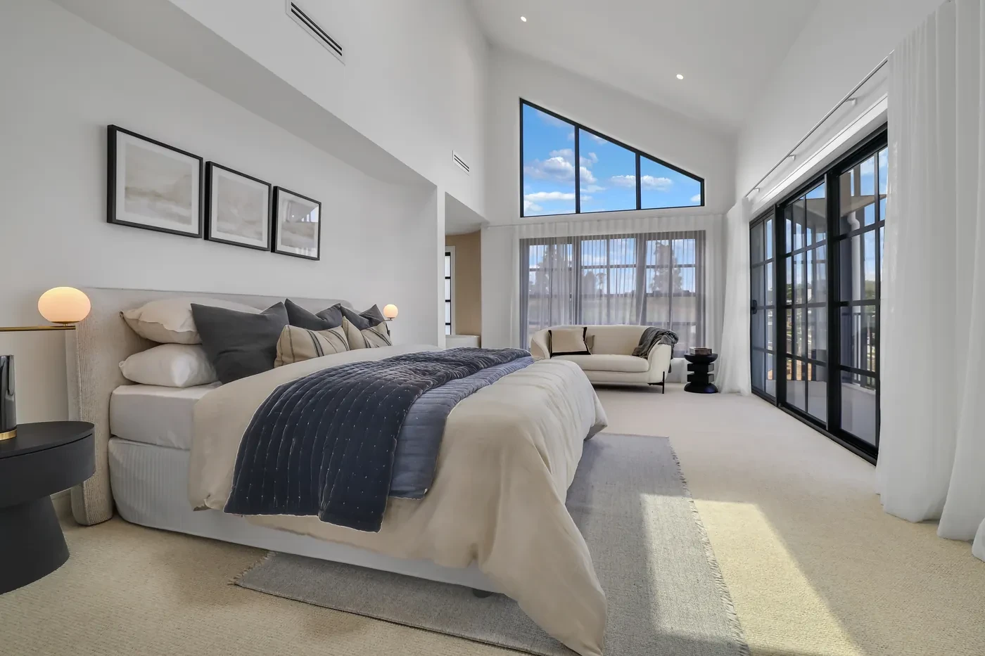 Master bedroom with sheer curtains at the glass doors Master bedroom with sheer curtains at the glass doors