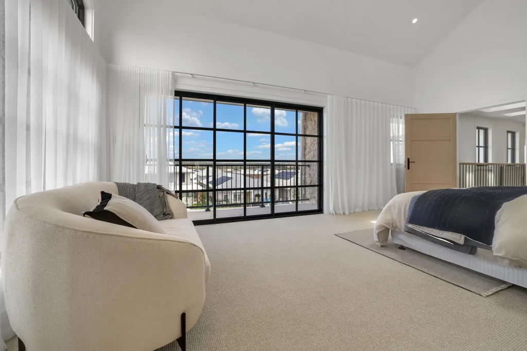 Master bedroom with sheer curtains and steel-framed doors Master bedroom with sheer curtains and steel-framed doors