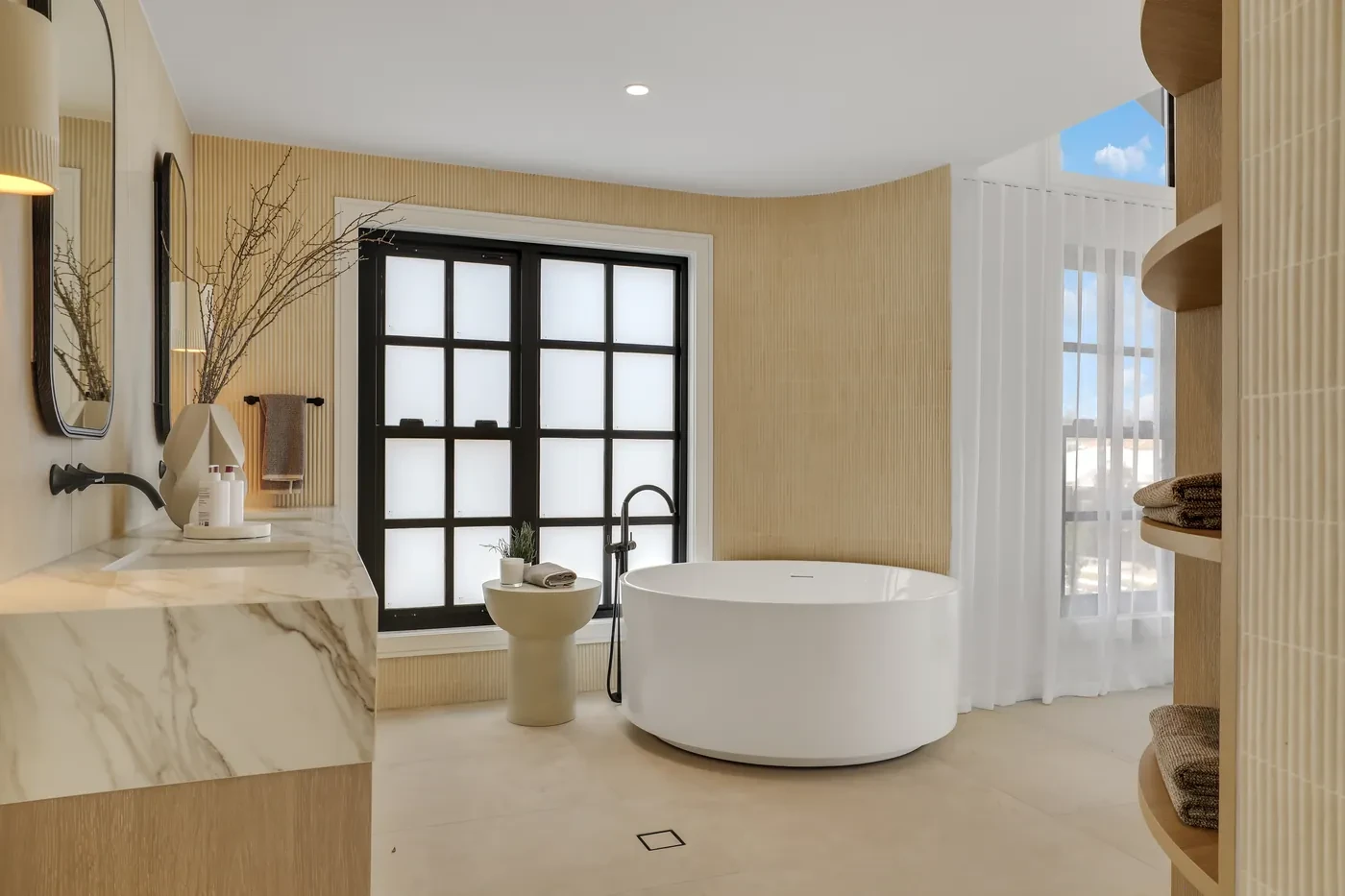 Bathroom with a round bath and sheer curtains Bathroom with a round bath and sheer curtains