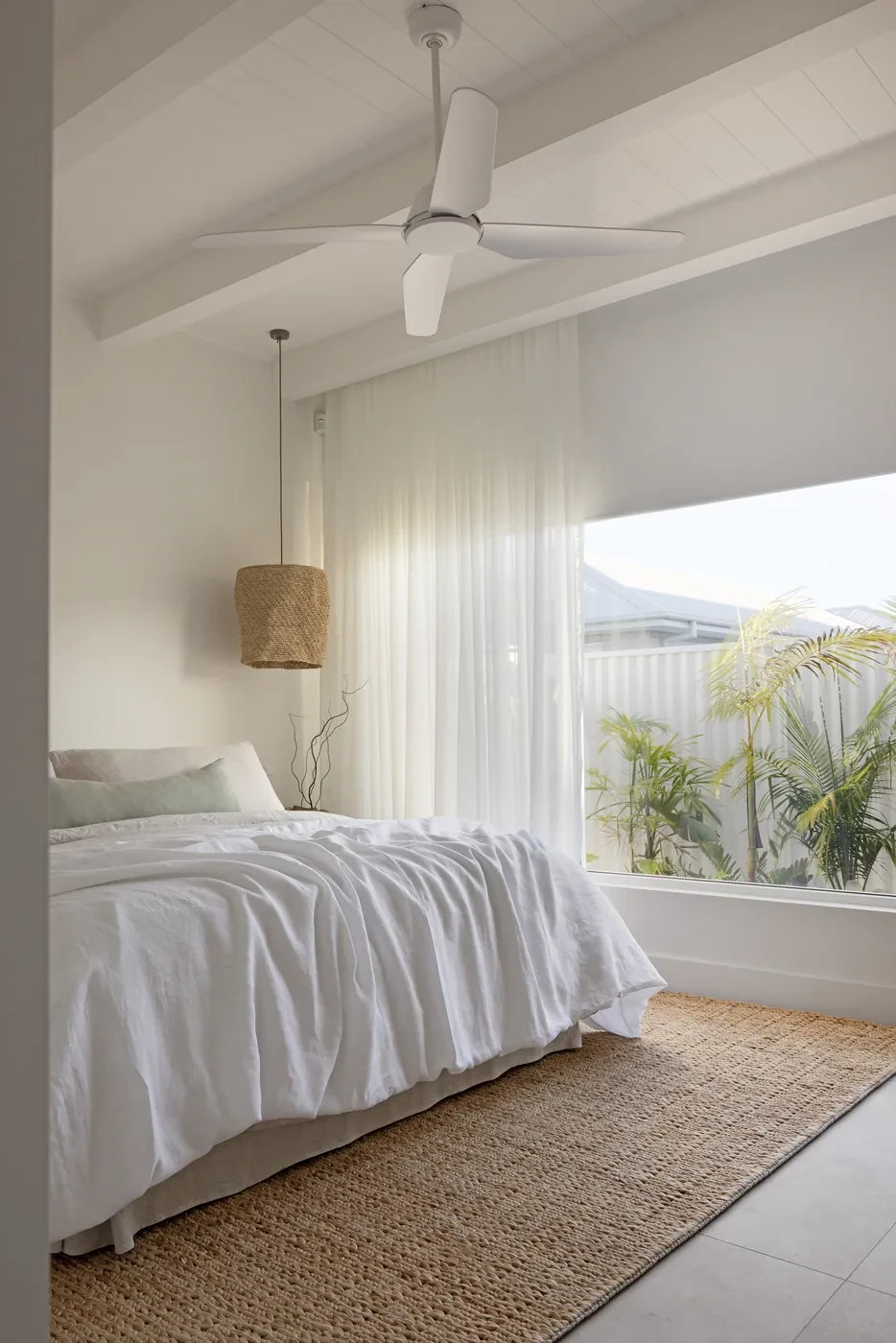 Bed beside a wall of sheer curtains Bed beside a wall of sheer curtains