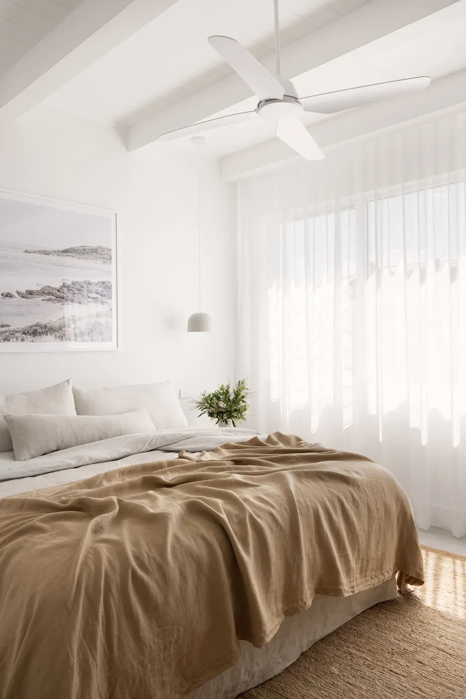 Bedroom with sheer curtains and a pendant light Bedroom with sheer curtains and a pendant light