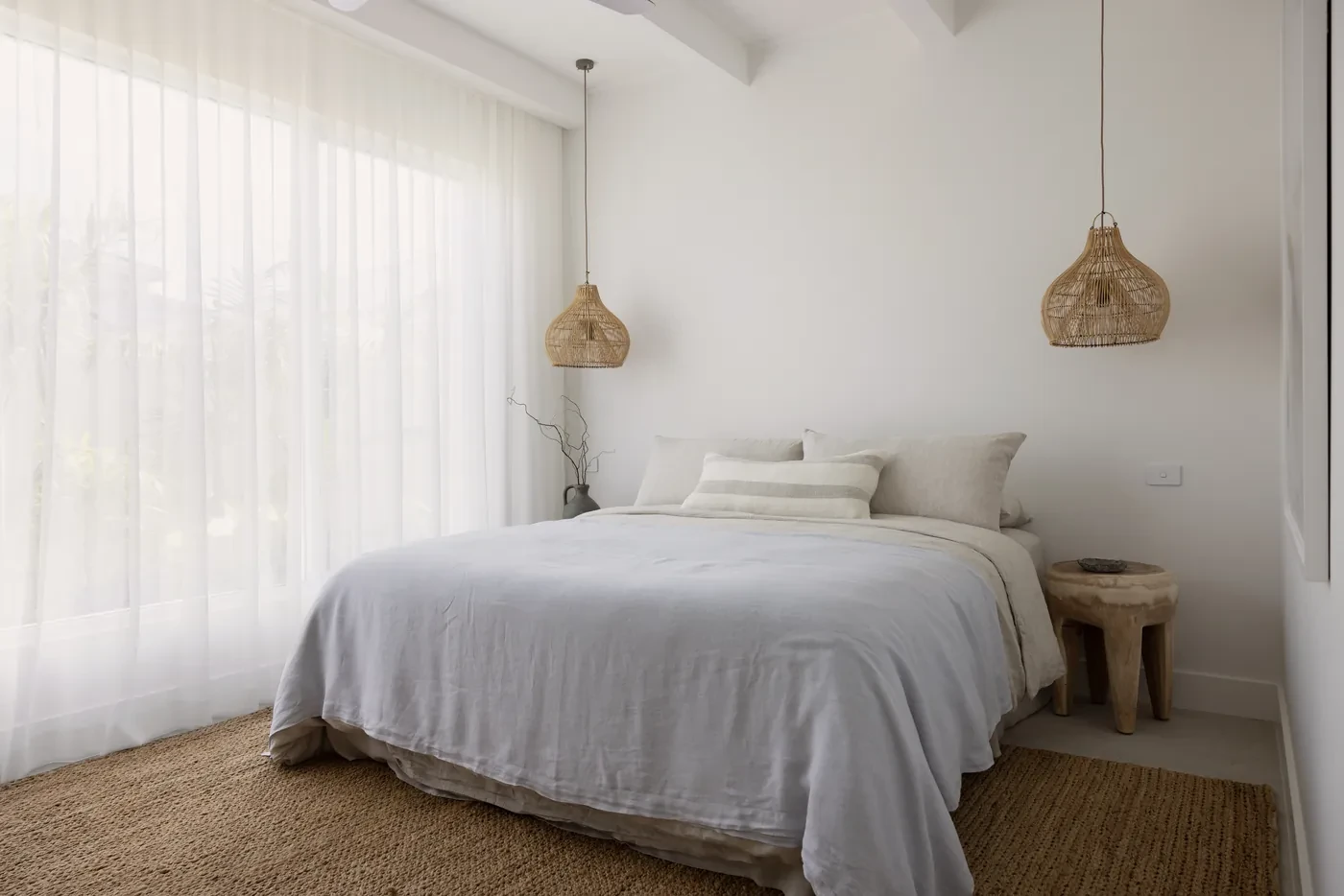 Bedroom with sheer curtains and rattan pendants Bedroom with sheer curtains and rattan pendants