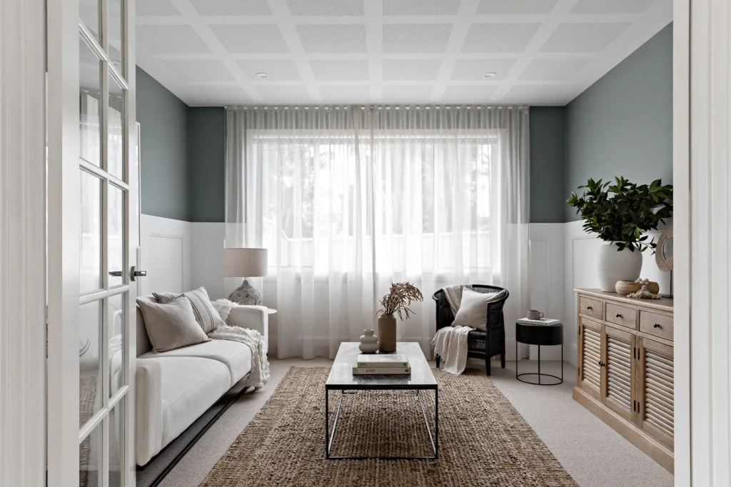Living room with sheer curtains and a jute rug Living room with sheer curtains and a jute rug