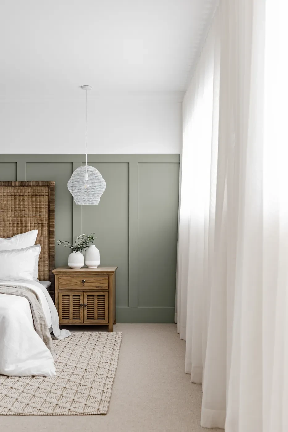 Bedroom with sheer curtains and a sage green wall Bedroom with sheer curtains and a sage green wall