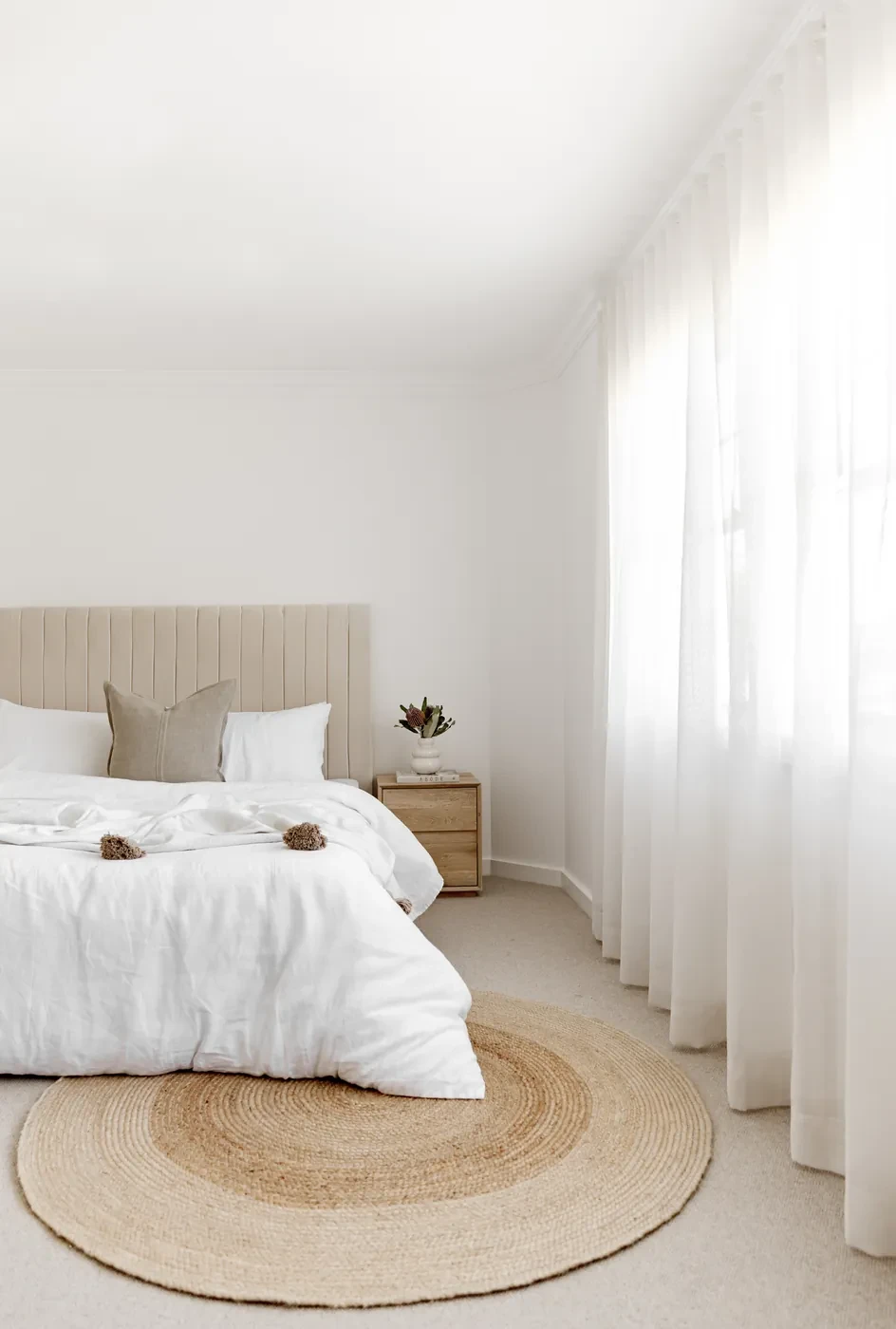 Bedroom with sheer curtains in soft light Bedroom with sheer curtains in soft light