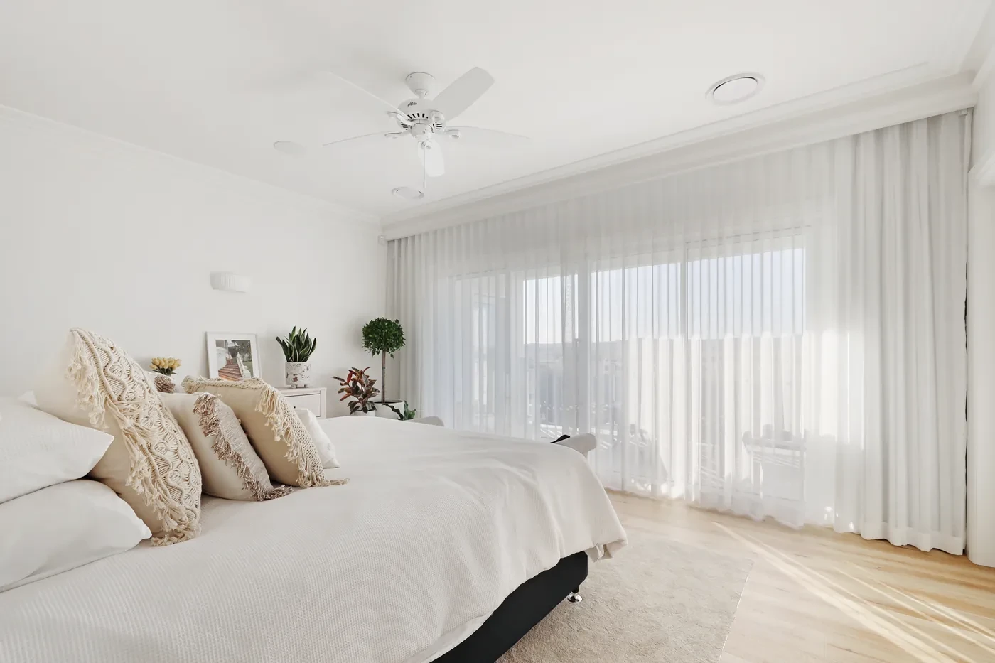 A wall of sheer curtains in a bedroom A wall of sheer curtains in a bedroom