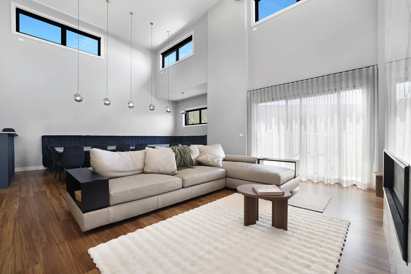 Sofa in front of sheer curtains in a double-height room Sofa in front of sheer curtains in a double-height room