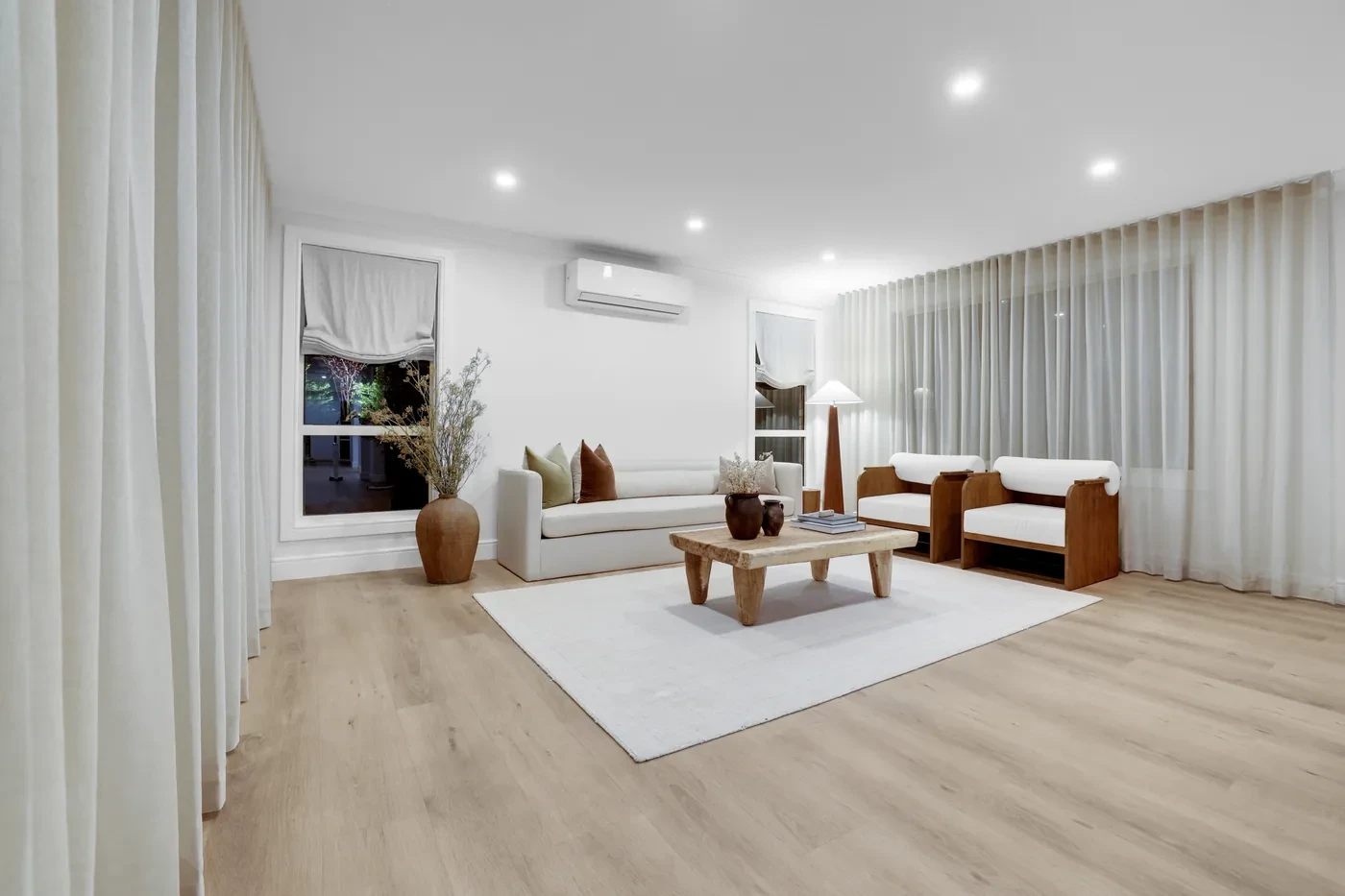 Living room with sheer curtains on two walls Living room with sheer curtains on two walls