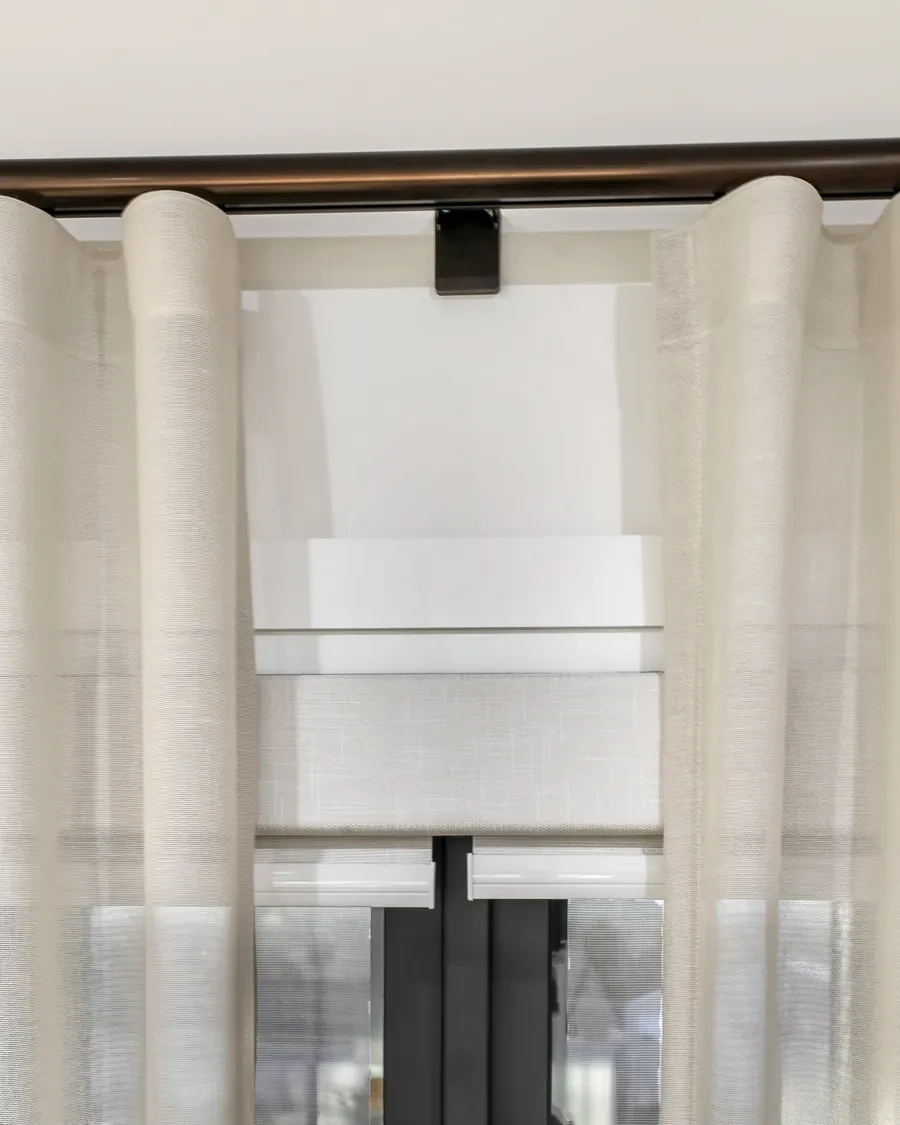 Double roller blind behind a sheer curtain