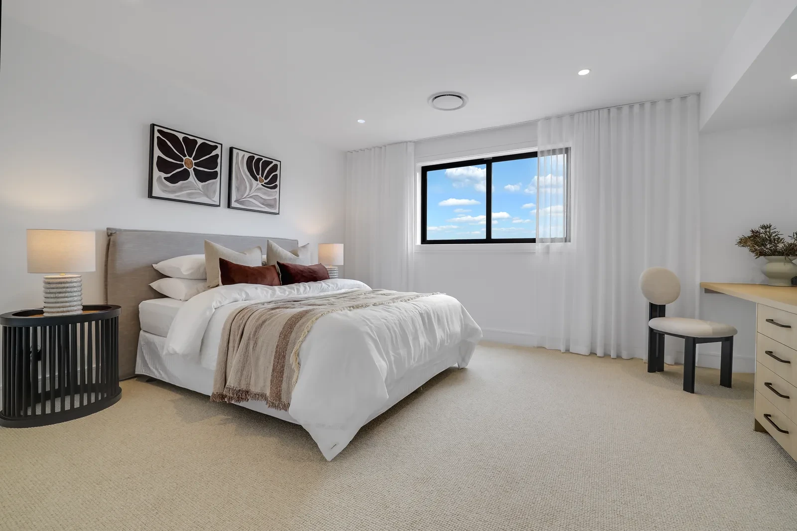 Bedroom in the Northwood 54 with white S-Fold sheer curtains on a ceiling-fit track