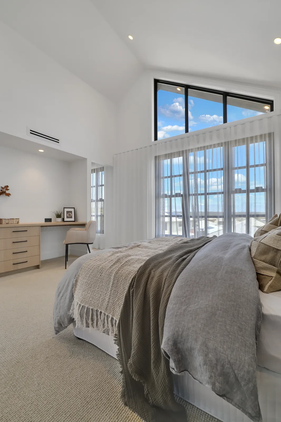 Main bedroom with white S-Fold sheer curtains across the gabled window and sliding door