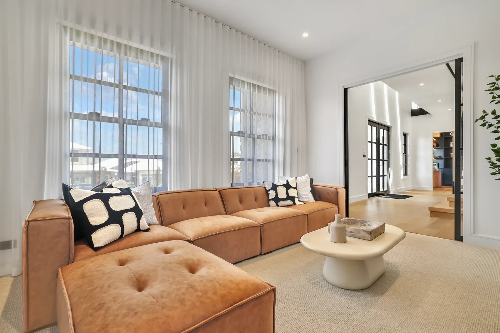 Living room with wall-to-wall white S-Fold sheer curtains