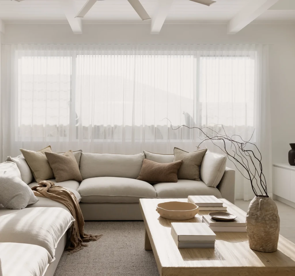 Sheer S-fold curtains in a light-filled living room, fitted by the owners