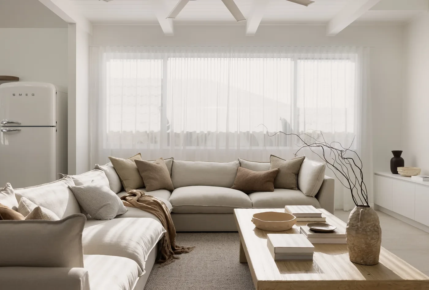 Wide living room wall of sheer curtains in soft light Wide living room wall of sheer curtains in soft light