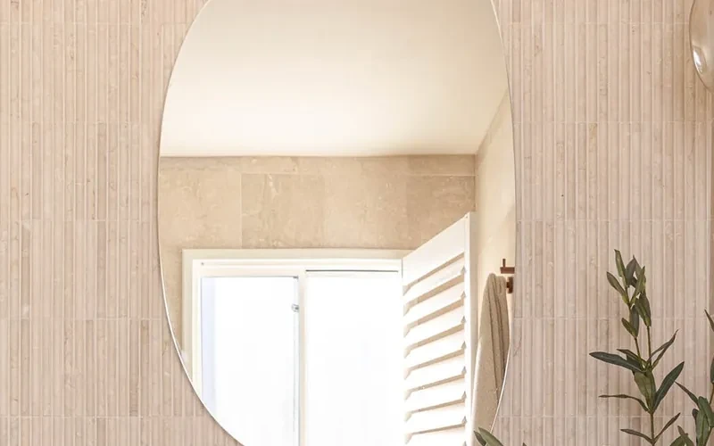 HAAUS.7 main ensuite: the open white PVC plantation shutter reflected in the vanity mirror