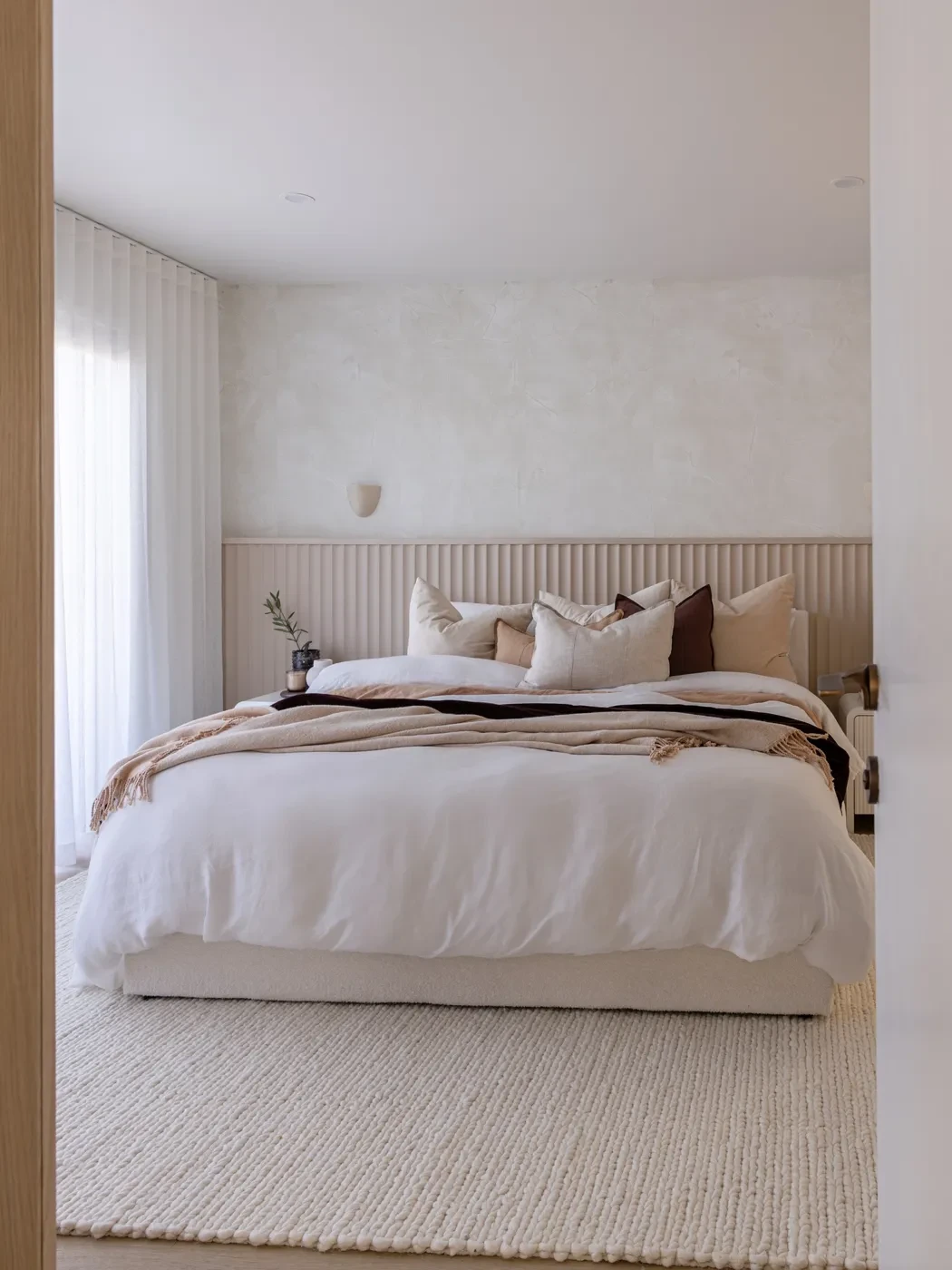 Main bedroom in HAAUS.7 with a white S-Fold sheer beside the bed