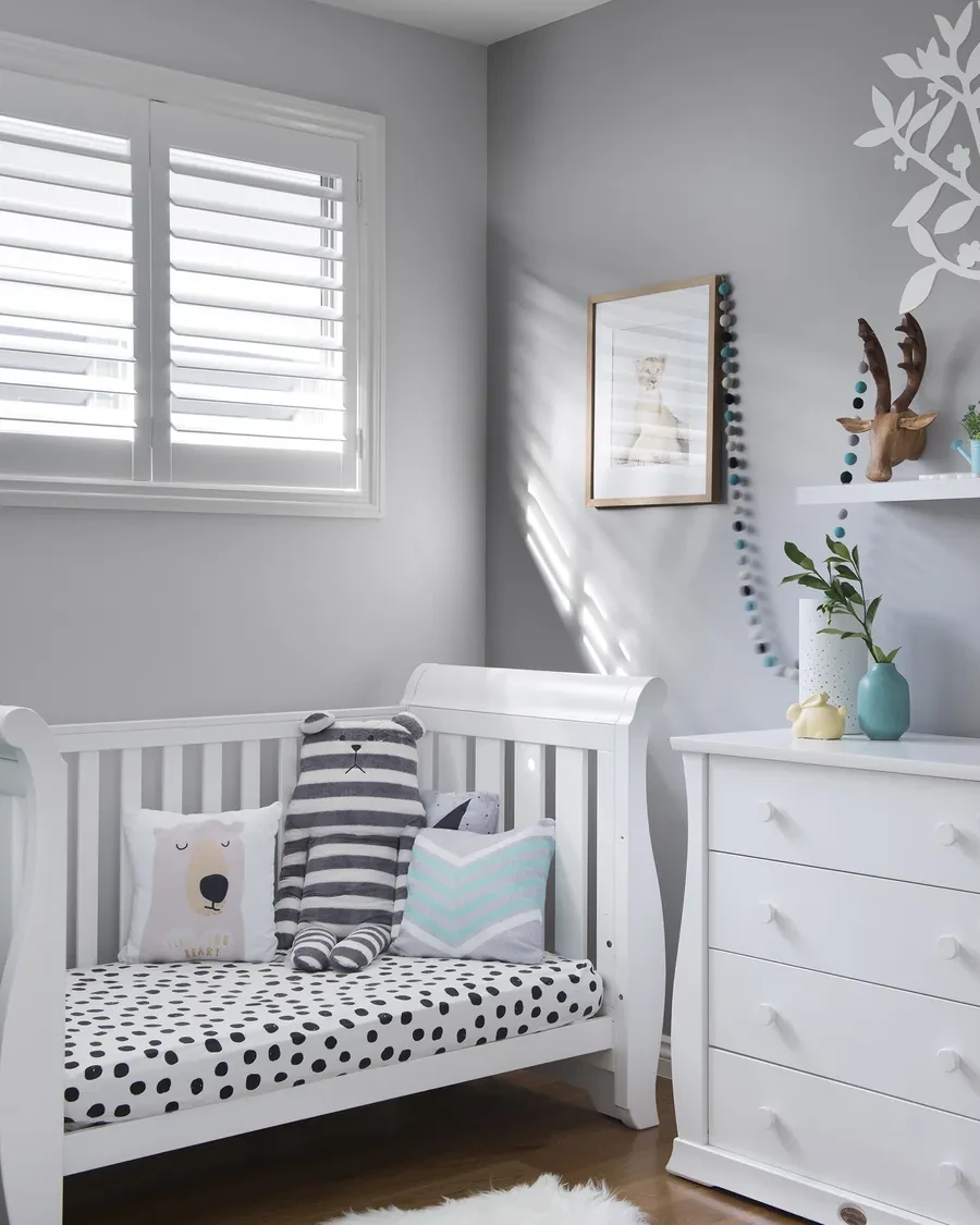 White plantation shutter on a nursery window, louvres tilted open