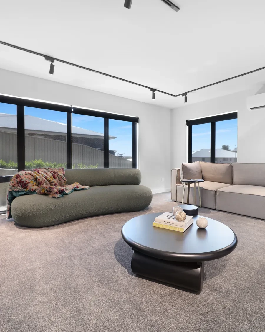 Charcoal sunscreen roller blinds in a modern living room