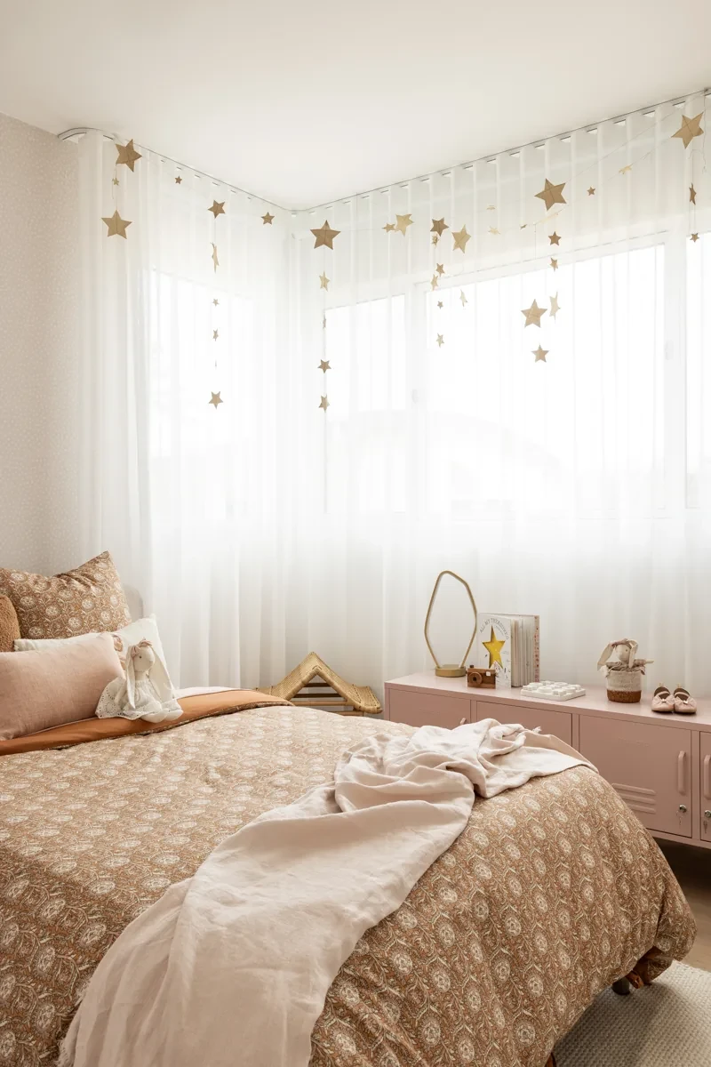 Sheer curtains in the corner of a kids bedroom