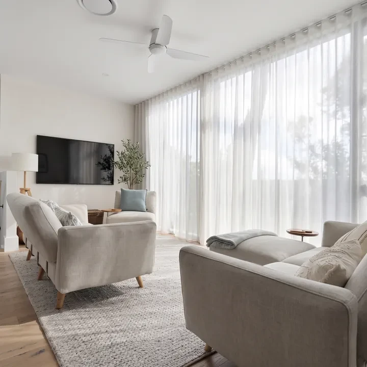 Sheer curtains glowing with daylight across a lounge room window
