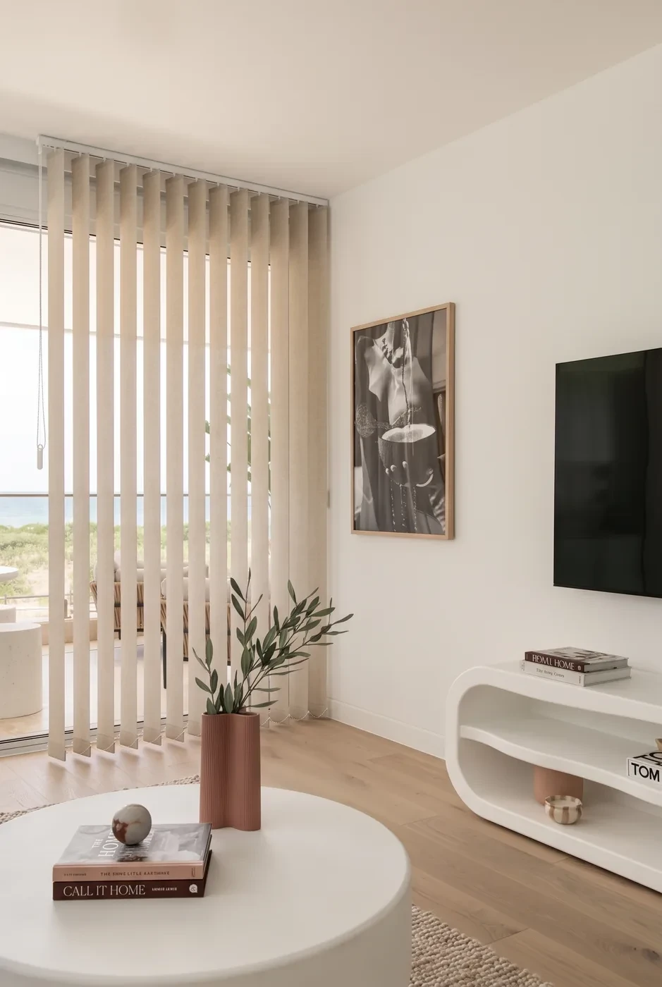 Oatmeal fabric vertical blinds across a living room sliding door, vanes half open