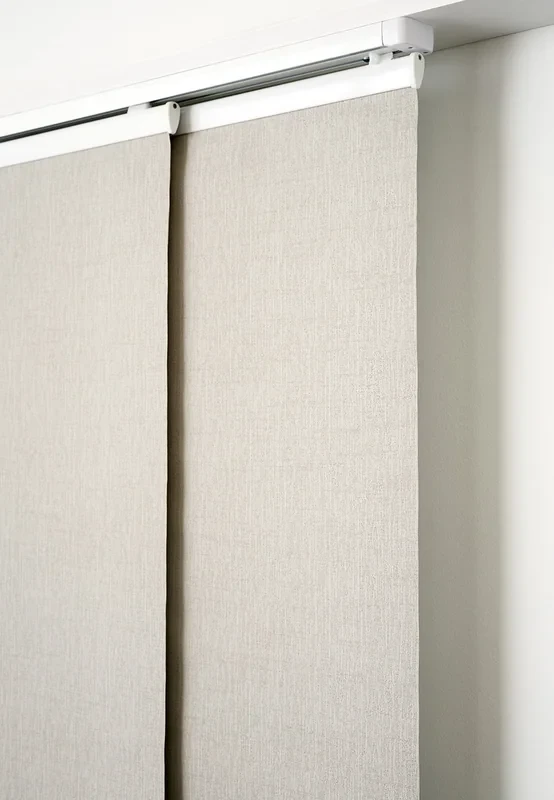 Detail of a panel glide multi-channel track at the ceiling line with two panels overlapping