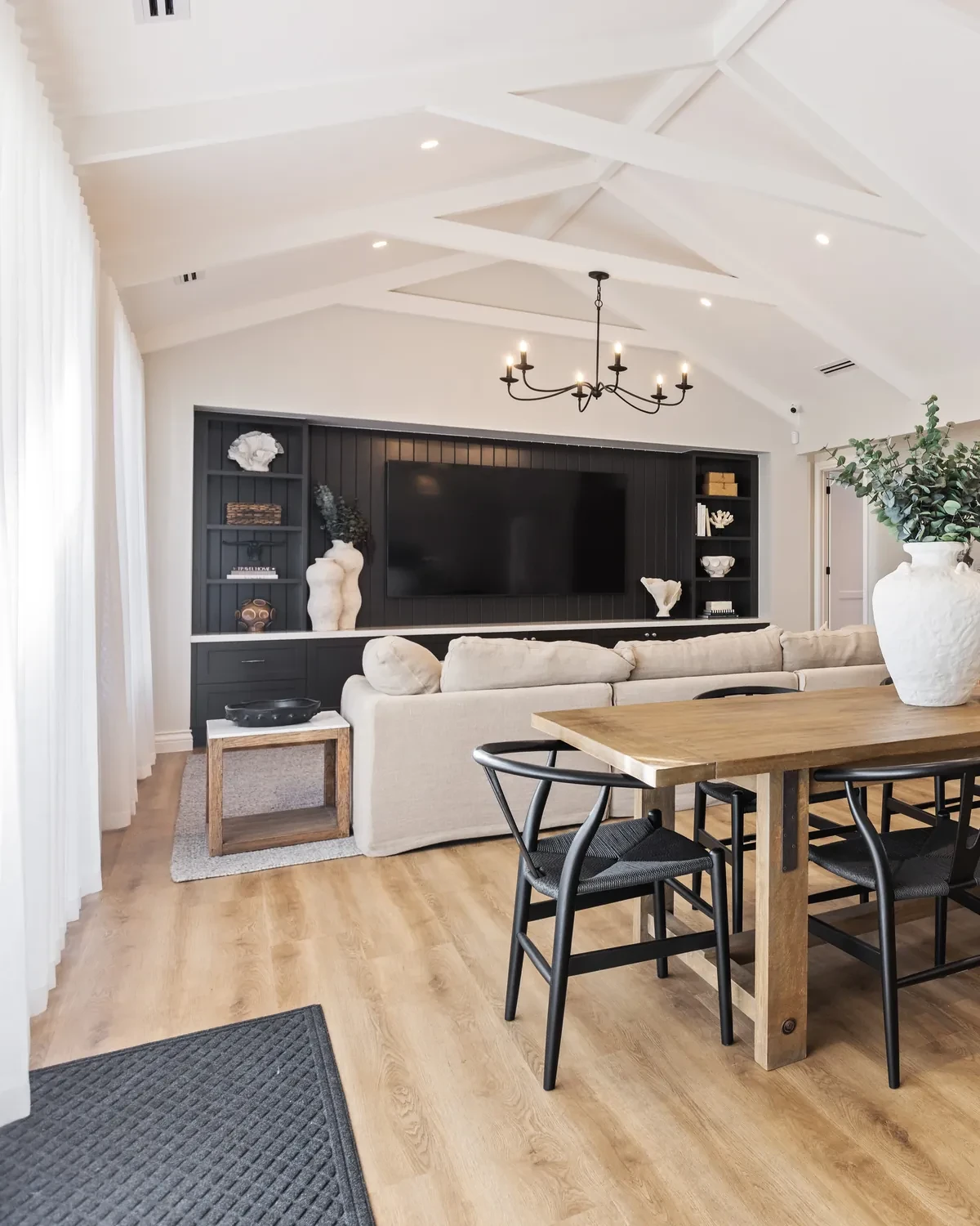 Living and dining area in the Ashbourne display home with Vevey Vanilla S-Fold sheers under a raked ceiling