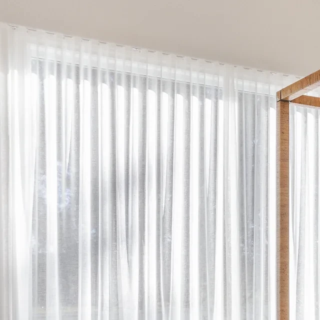 Close-up of the Vevey Vanilla S-Fold sheer in the Ashbourne main bedroom, showing the even folds along the ceiling track