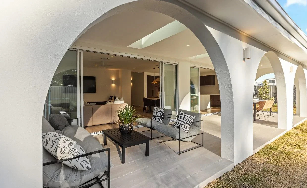 Alfresco in the Mariote 39 display home: an outdoor lounge under white arches