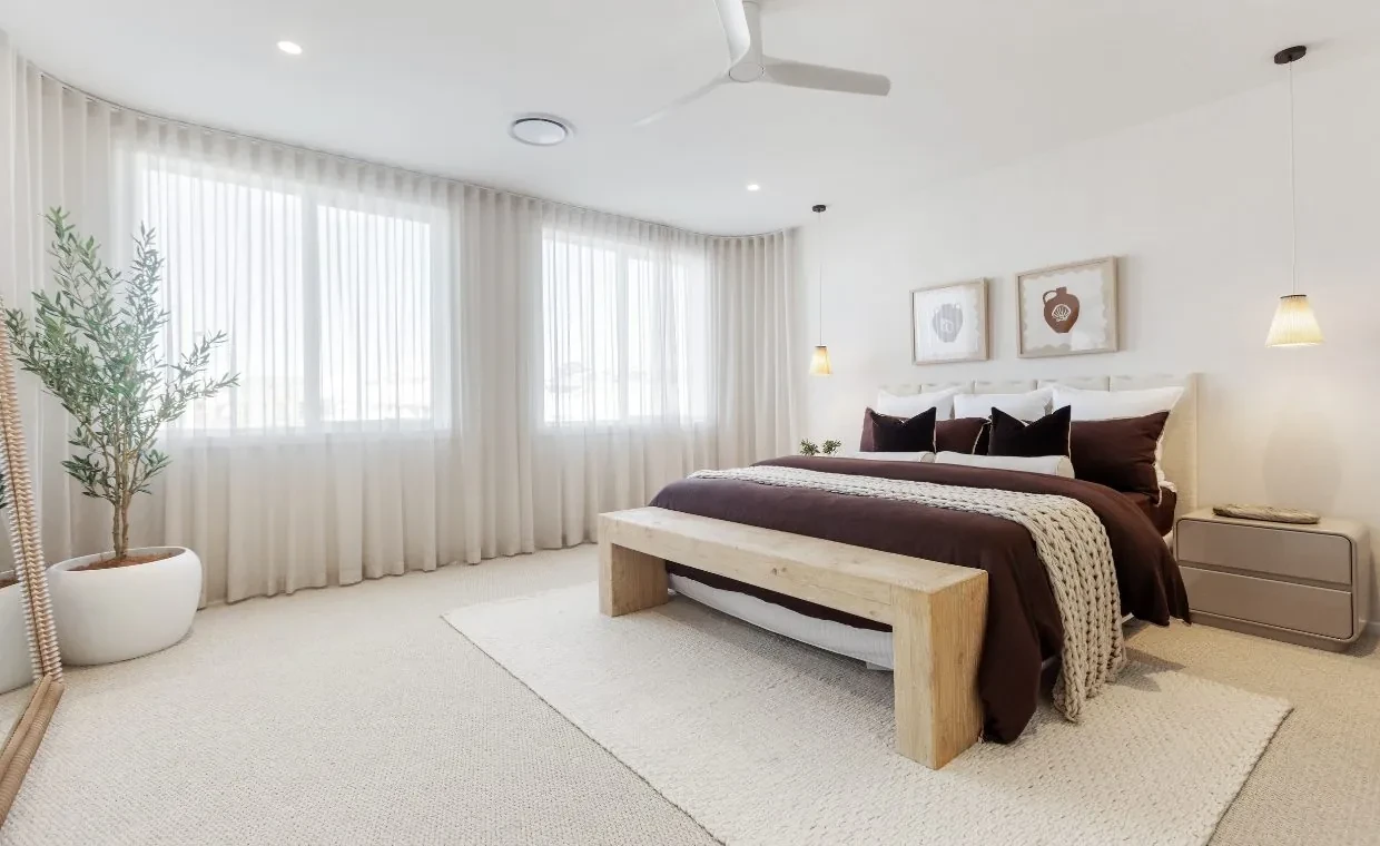 Main bedroom in the Mariote 39 display home with floor-to-ceiling S-Fold sheer curtains across the window wall