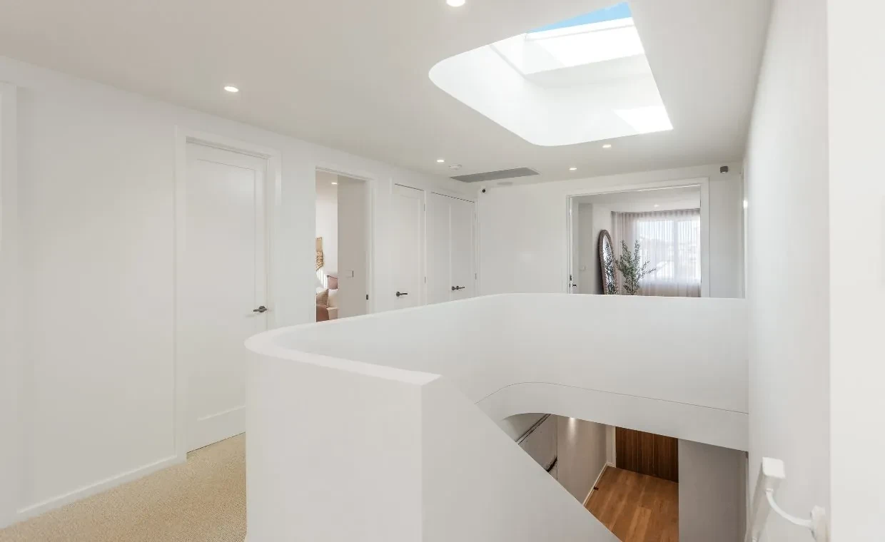 Upstairs landing in the Mariote 39 display home: a curved white balustrade under a skylight