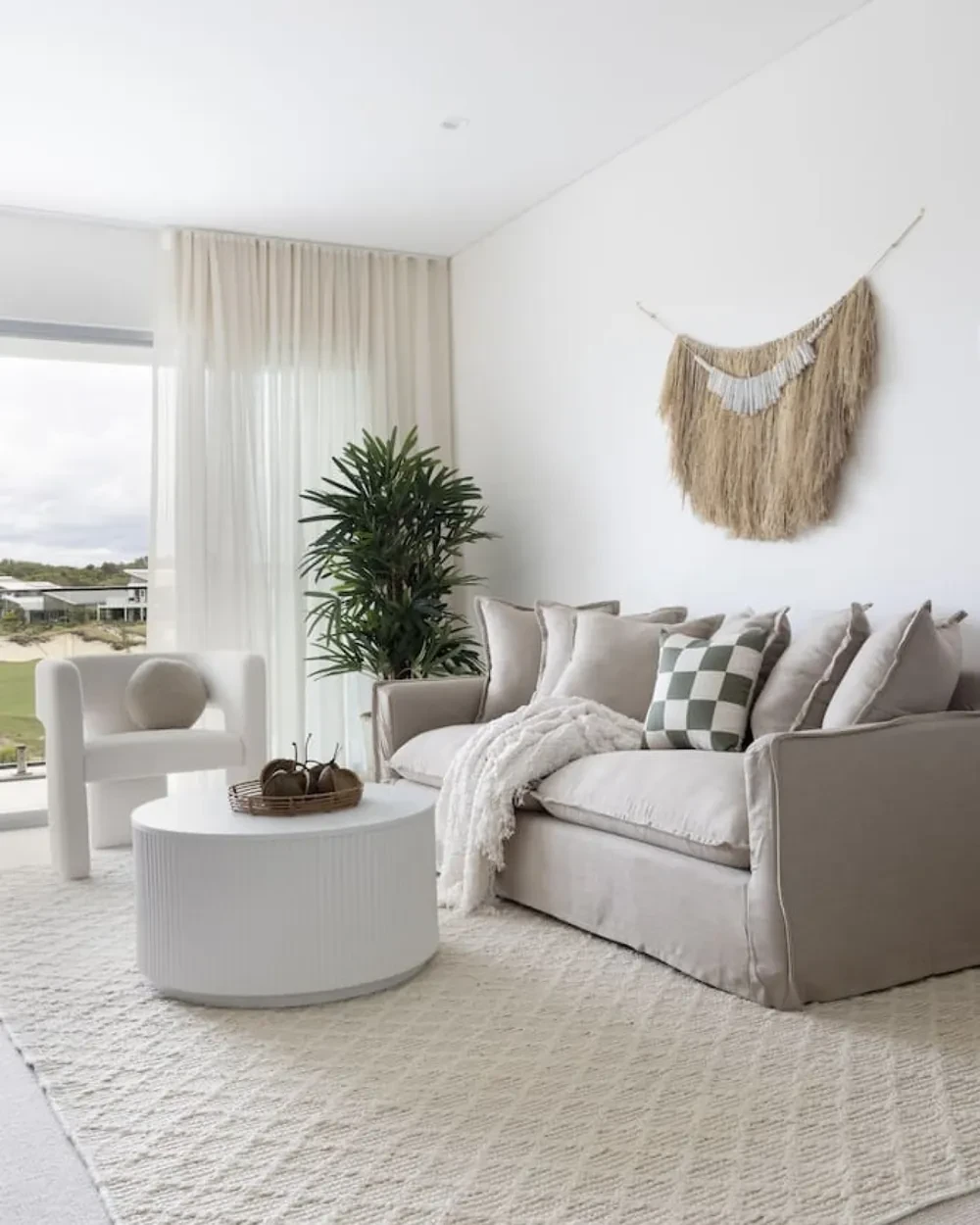 Second lounge at Magenta Palms with sheer curtains on the window to the golf course
